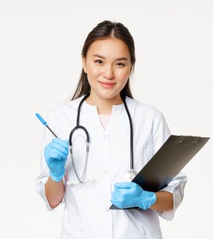 Smiling asian doctor, female nurse holding clipboard and pen, wearing uniform with gloves, writing patient information, standing over white background.